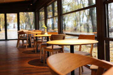 Stylish cafe with large windows and comfortable furniture. Interior design