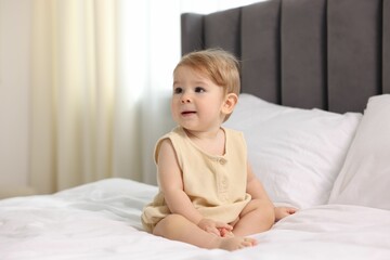 Fototapeta premium Cute little baby on bed at home