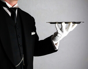 Butler or Formal Waiter In White Gloves Holding Serving Tray. At Your Service.