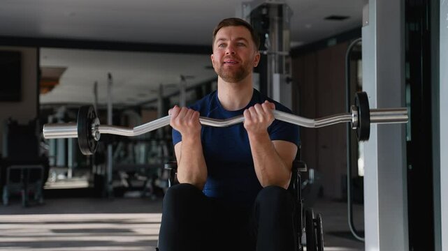 Smiling man in wheelchair lifting barbell at gym