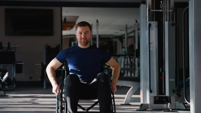 Man in wheelchair moving through gym after workout