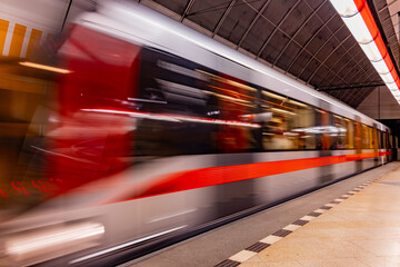 A moving subway train in a station