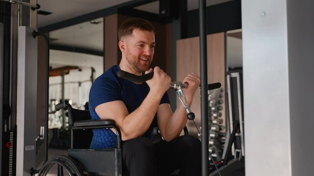 Man in wheelchair training biceps on cable machine