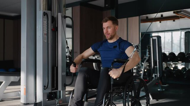 Man in wheelchair performing cable crossover exercise