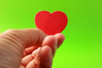 Fototapeta premium Hand offering a red heart