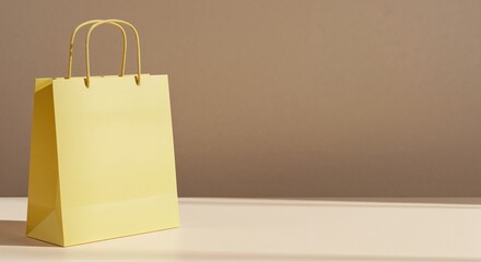 Yellow shopping bag mockup on beige surface with soft sunlight and copy space for branding, retail marketing, or product presentation