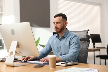 Fototapeta premium Man working on computer at desk in office