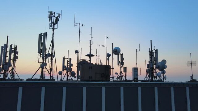 Rooftop base station antennas emitting electromagnetic radiation waves