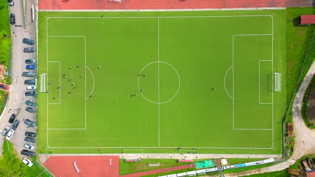 Aerial view of a soccer field with players moving like in a video game