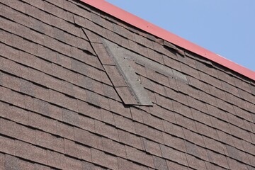 Shingle Hanging Loose from Mansard Roof