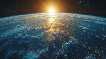 Earth view from space with sun rising over horizon showing clouds and atmosphere.