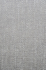 Detailed close-up of a woven textile showcasing intersecting light gray threads forming a grid-like pattern