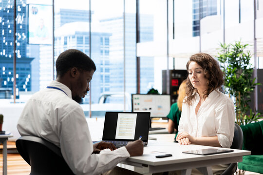 HR employee determining if african american candidate possesses skills and experience needed to fulfil role. Employer evaluating if applicant qualifications align with diverse workplace company