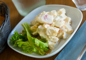 Portion of salad with mayonnaise sauce and vegetables
