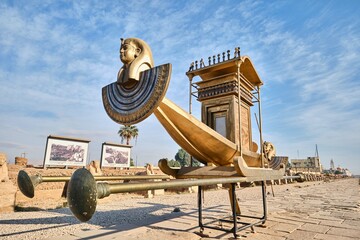 Luxor, Egypt - December 26 2023: A royal boat installed on the avenue of sphinxes facing the...