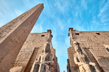 Luxor, Egypt - December 26 2023: Luxor Temple main entrance, first pylon with obelisk and statues...