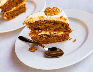 Sweet dessert, carrot cake with walnuts on white plate