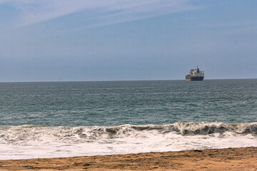 Golden Sandy Beach with Blue Ocean and Boat in Manzanillo, Colima, Mexico