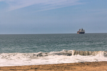 Golden Sandy Beach with Blue Ocean and Boat in Manzanillo, Colima, Mexico