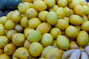 Many of whole ripe lemons, put up for sale. Vitamin fruits