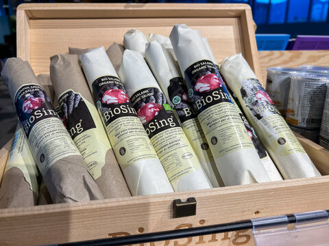 Brnik, Slovenia &ndash; 27 April 2025: BioSing Cured Meats, dry Sausage, bio organic salami  in Branded Wooden Crate