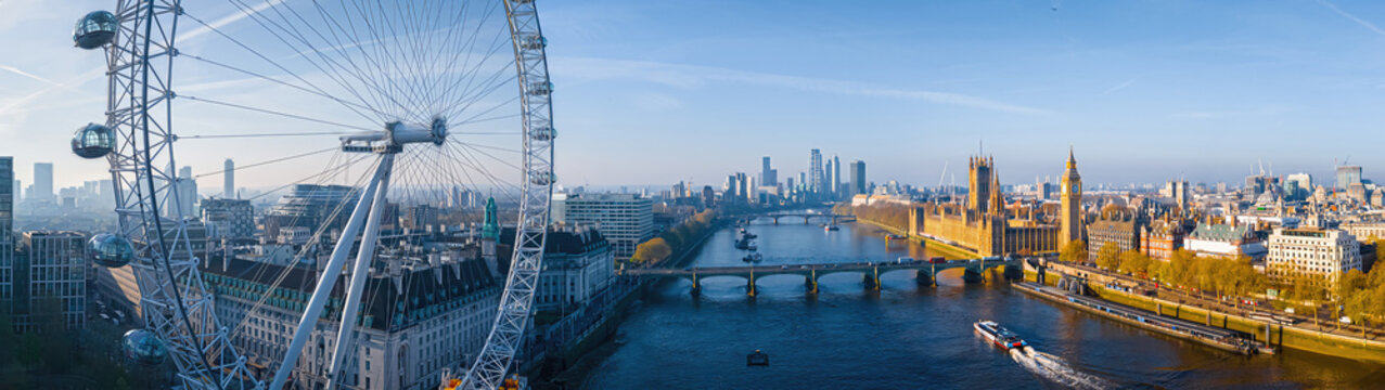 Iconic London skyline with London Eye in morning light over the Thames