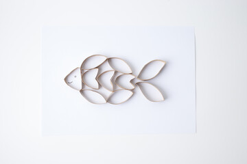 DIY fish figure made from toilet paper rolls for educational apps, early learning kits, art supply brands, and eco-friendly content. Visual promotes creativity and material reuse