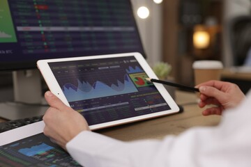 Stock exchange. Woman working at desk in office, closeup