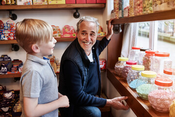 Man, child and jar candy shop with question for gift, shopping and choice with love, care and...
