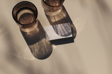 Summer neutral branding stationery. Closeup of blank business card, invitation mockup. Two glass of...