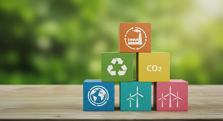 Entrepreneurship, startup, corporate colorful wooden blocks stacked in a pyramid shape with symbols of sustainability on a wooden surface