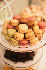 Close-up of assorted macarons stacked on a tiered dessert tray