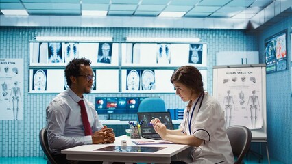 Female doctor and patient engage in a medical consultation with diagnostic tools and x ray imaging...