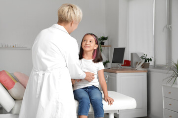 Fototapeta premium Little Asian girl visiting pediatrician in clinic