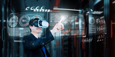 Businessman with headset standing at data center while analyzing financial data. Manager pointing...