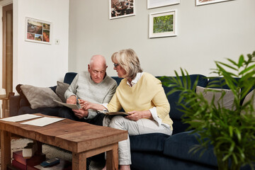 Senior couple, bills and reading documents for planning budget, financial assets and insurance...