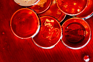 Euro coins in blood.red blood on coins close up. dirty money.Macro Shot of Euro Coins in Blood .Money drowns in blood.
