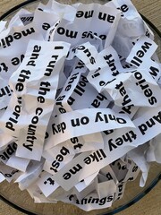 Word salad jumble of crumpled strips of paper with words and phrases