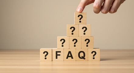 Entrepreneurship, startup, corporate a hand placing a question mark block on a pyramid of faq blocks on a wooden surface with a beige background
