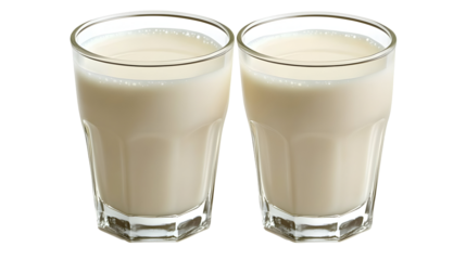 Isolated view of two clear glass filled with milky fluid against black background