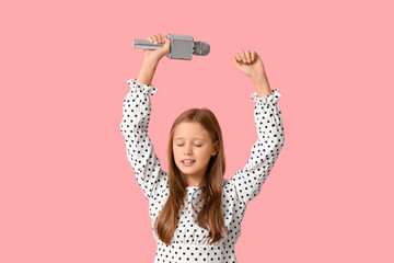 Cute girl with modern microphone on pink background
