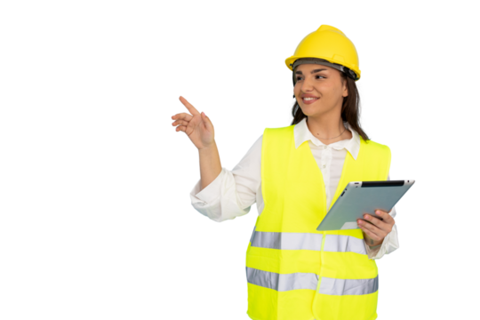 Professional female engineer wearing safety gear, gripping digital tablet and indicating details against isolated white backdrop
