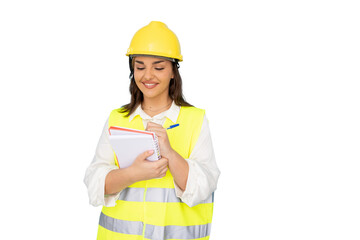 Female architect wearing safety helmet, drafting project notes, standing near blueprints with professional posture