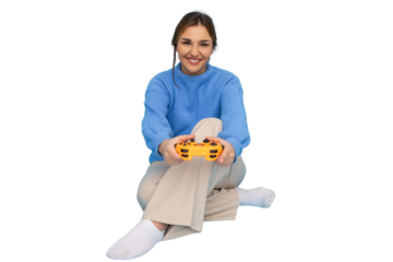 Happy young woman sitting with crossed legs holding a controller playing videogames with transparent background