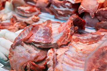 Raw pork ribs laid out on counter in butcher shop