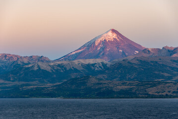 sunrise at lago huechulafquen and peak of lanin volcano at lanin national park, patagonia, argentina