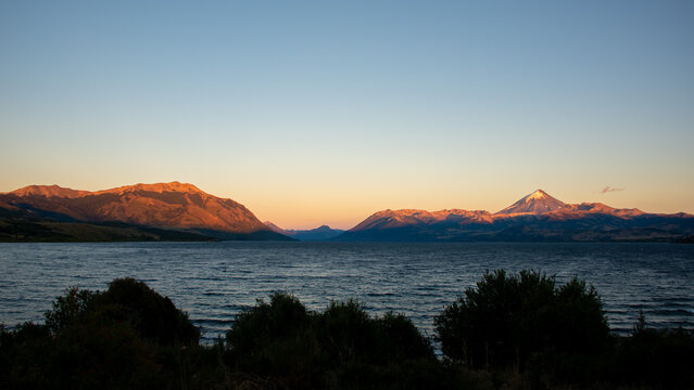 Sunrise at lago huechulafquen and peak of lanin volcano at lanin national park, patagonia, argentina