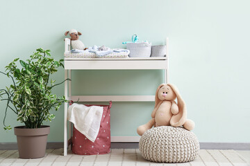 Interior of nursery with changing table and pouf