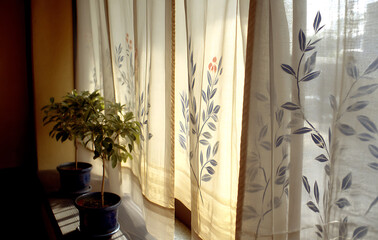 Sunlight Illuminates Sheer Curtains with Leaf Pattern Near Potted Plants
