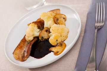 Cauliflower with bacon and mushrooms. High quality photo